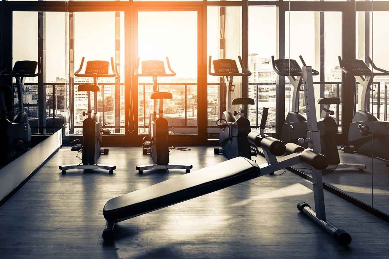 Fitness room with upright bikes at sunrise
