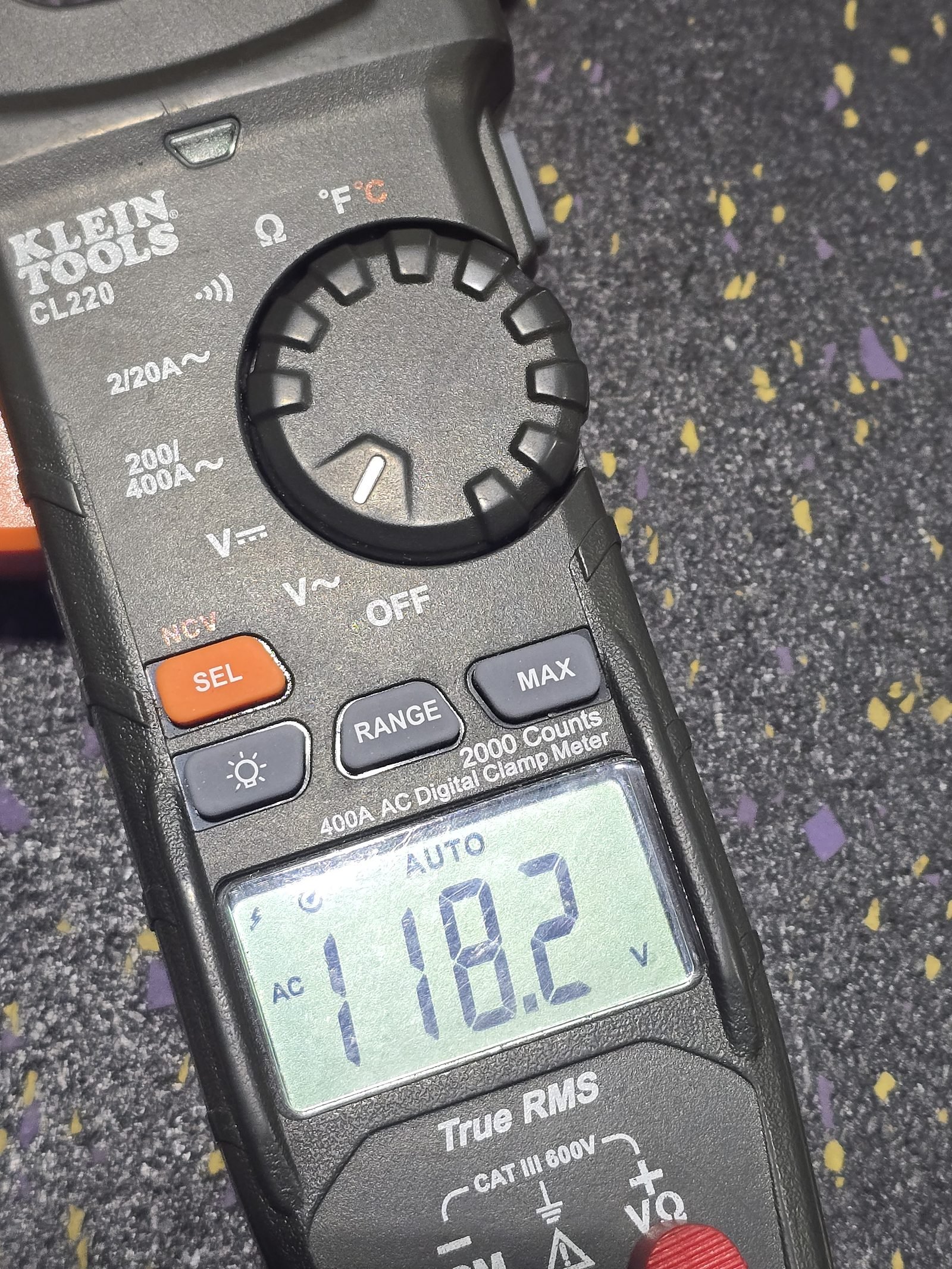 Technician testing treadmill wiring with a multimeter