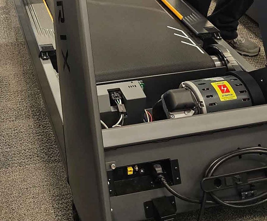 Treadmill motor compartment open for testing