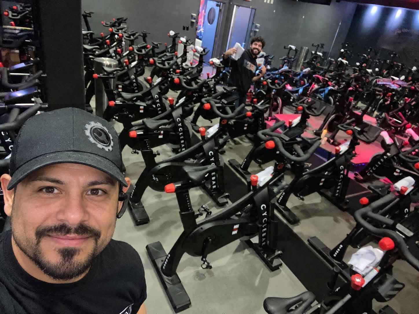 ServiceRX technicians in a studio full of indoor cycling bikes