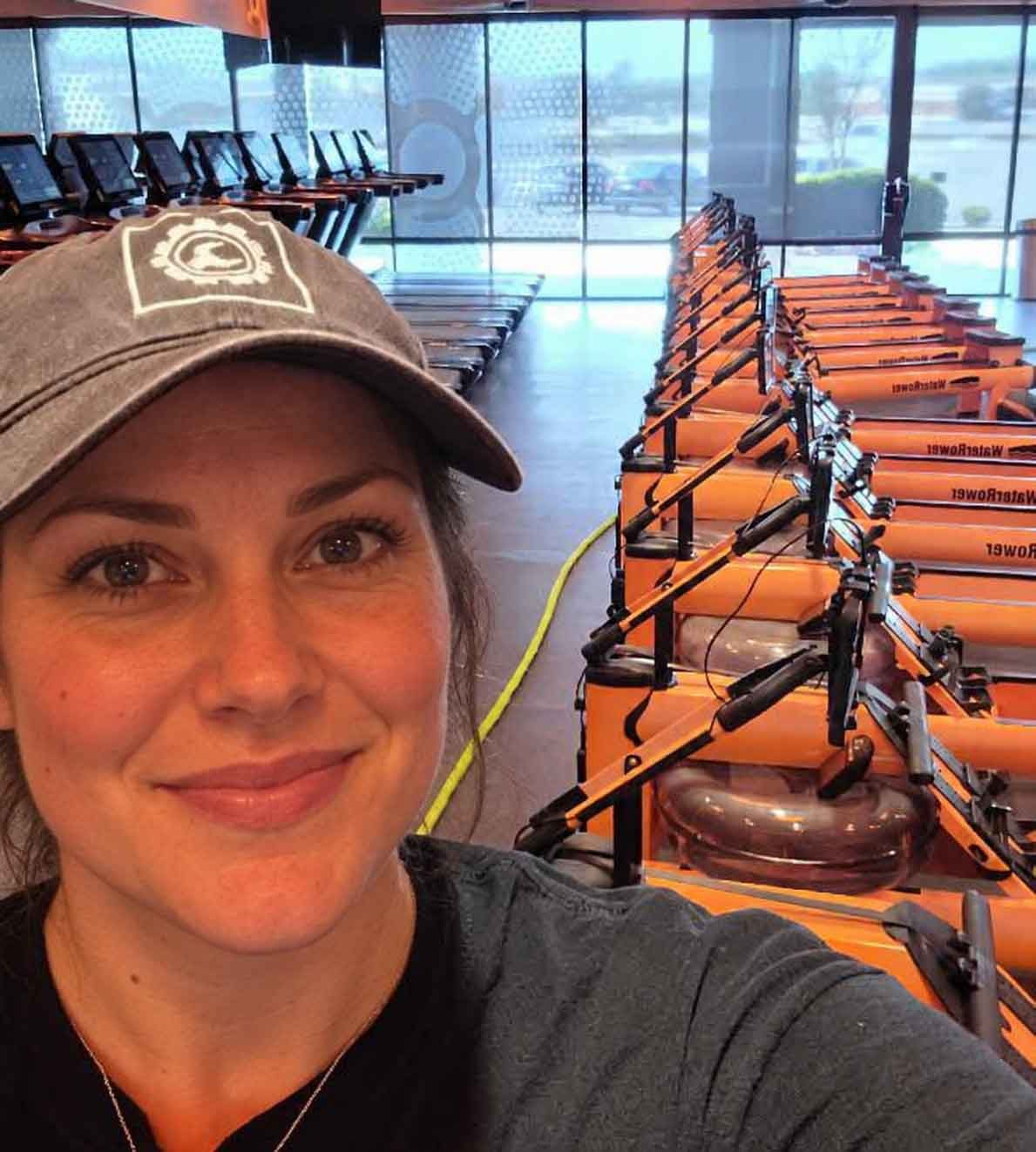 ServiceRX technician in a studio beside a line of WaterRower machines